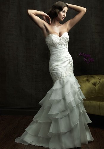 Gown features beading, ruching, ruffled skirt, and Swarovski crystals.