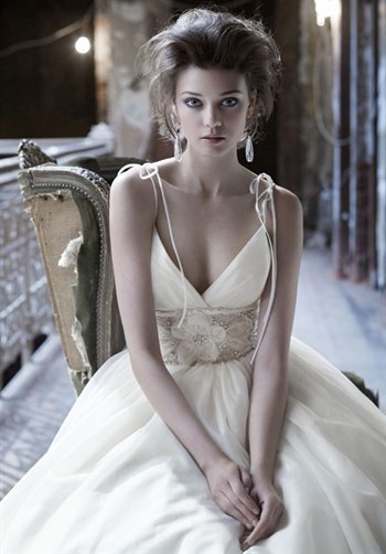 Gown features tied straps, beaded floral cummerbund, gathered skirt, and side pockets.