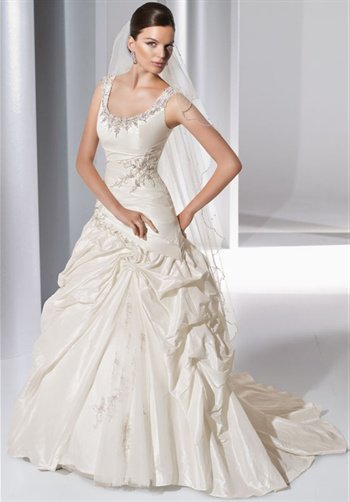 Gown features asymmetric-waist and beading.